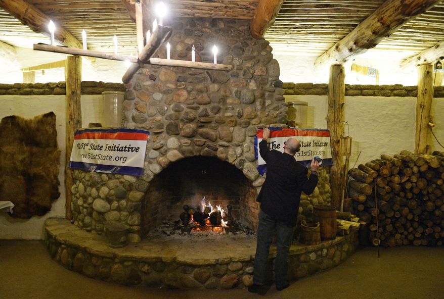 Jeffrey Hare, of the 51st State Initiative, hangs a banner before an election result watch party at the Historic Fort Lupton Fort, Tuesday, Nov. 5, 2013, in Fort Lupton, Colo. Eleven counties are voting to secede from Colorado to form the 51st state. (AP Photo/The Denver Post, RJ Sangosti) MAGS OUT; TV OUT; INTERNET OUT; NO SALES; NEW YORK POST OUT; NEW YORK DAILY NEWS OUT