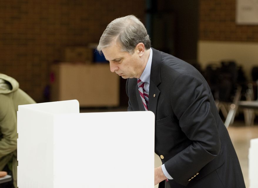 Harrisonburg Sen. Mark Obenshain, Republican candidate for attorney general, marks his ballot at the Thomas Harrison Middle School West Central Precinct Tuesday, Nov. 5, 2013 in Harrisonburg, Va. Obenshain faces Sen. Mark Herring, D-Loudoun. (AP Photo/The Daily News-Record, Michael Reilly)