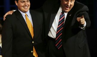 Republican New Jersey Gov. Chris Christie waves as he stands with his son Andrew as they celebrate his election victory in Asbury Park, N.J., Tuesday, Nov. 5, 2013, after defeating Democratic challenger Barbara Buono . (AP Photo/Mel Evans)