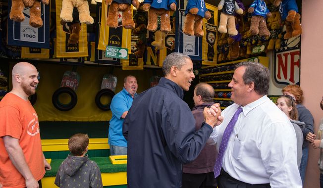 President Barack Obama congratulates New Jersey Governor Chris Christie while playing the &quot;TouchDown Fever&quot; arcade game along the Point Pleasant boardwalk in Point Pleasant Beach, N.J., May 28, 2013. (Official White House Photo by Pete Souza)