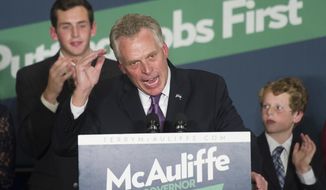 Virginia Democratic Gov.-elect Terry McAuliffe address his supporters, as his sons Jack, 20, left, and Peter, 11, right, look on, during an election victory party at Tysons Corner, Va., Wednesday, Nov. 6, 2013. (AP Photo/Cliff Owen)