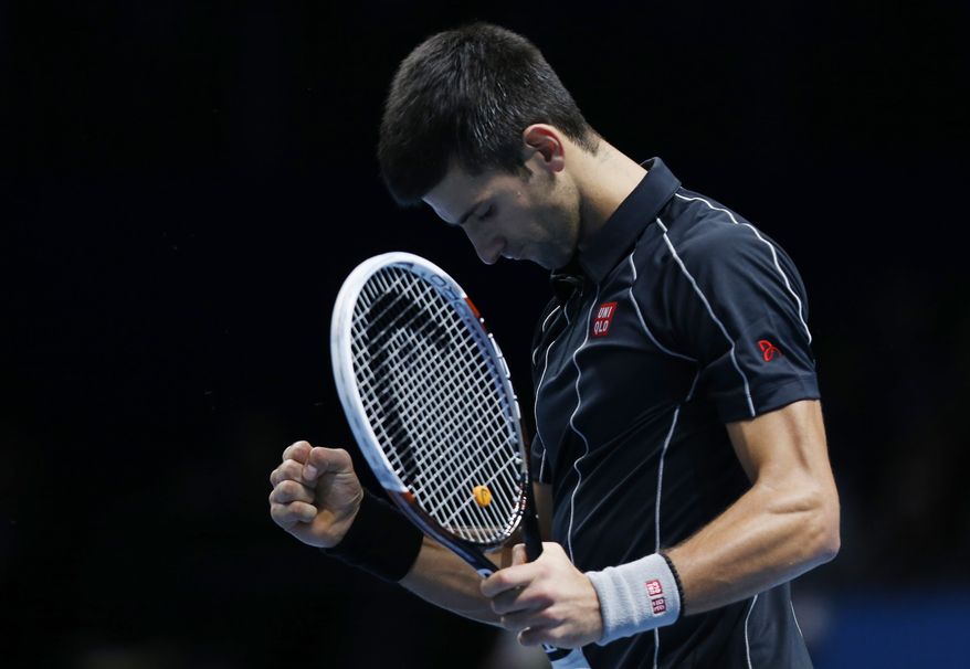Novak Djokovic of Serbia celebrates his win against Juan Martin Del Potro of Argentina at the end of their ATP World Tour Finals single tennis match at the O2 Arena in London Thursday, Nov. 7, 2013. (AP Photo/Sang Tan)