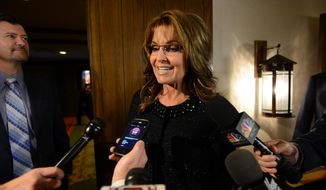 Former Alaska Gov. Sarah Palin, the 2008 Republican vice presidential nominee, talks to the media before the Rev. Billy Graham&#39;s 95th birthday party at the Grove Park Inn in Asheville, N.C., on Thursday, Nov. 7, 2013. (AP Photo/The Asheville Citizen-Times, Erin Brethauer)