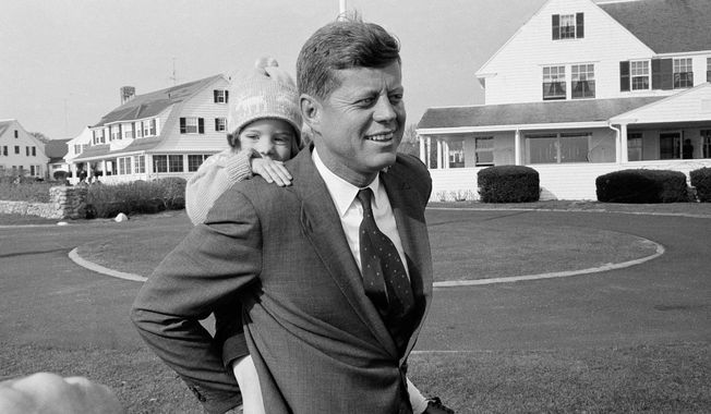 ** FILE ** In this Nov. 9, 1960, file photo, Caroline Kennedy gets a piggy-back ride from her father, Sen. John F. Kennedy, in Hyannis Port, Mass. It was the first chance in weeks Kennedy has had to relax with his daughter during his presidential campaign. (AP Photo)