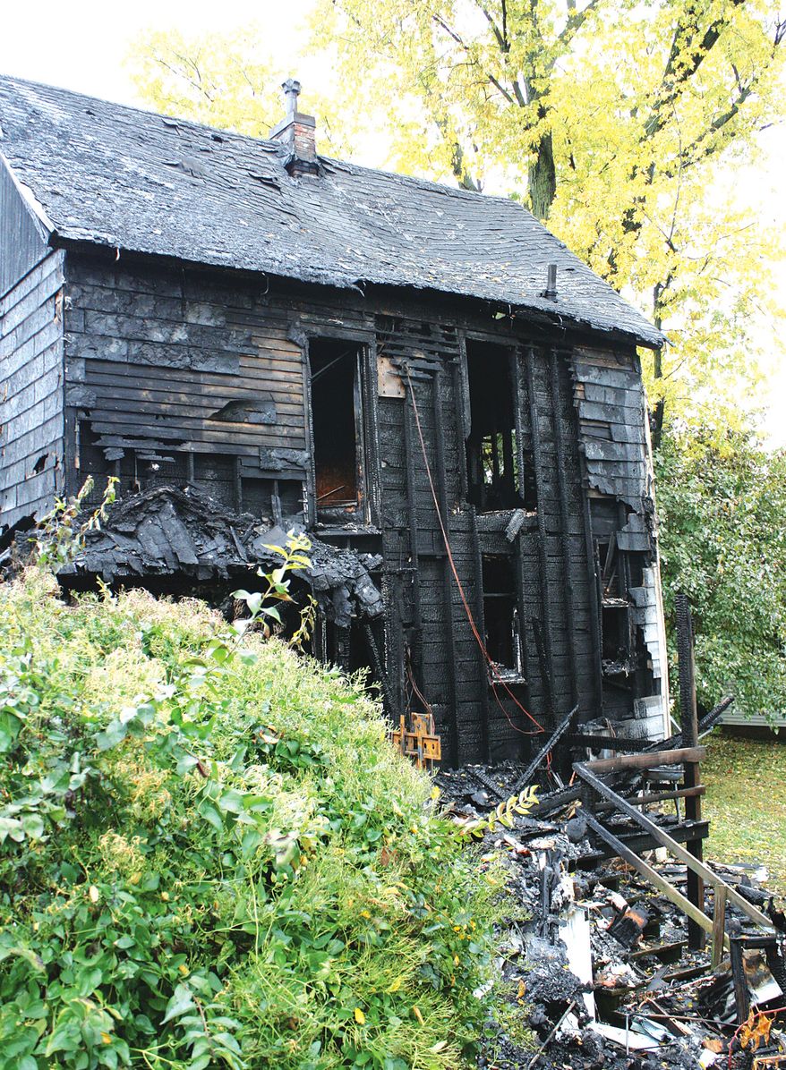 The back of a Louisiana, Mo., house in which 3-year-old Riley Jeffrey Rieser was killed in a fire is pictured on Thursday, Oct. 31, 2013. The child's mother and stepfather were outraged after police used a stun gun on the man as he tried to run back in and save the boy. (AP Photo/Louisiana Press-Journal, Tim Schmidt)