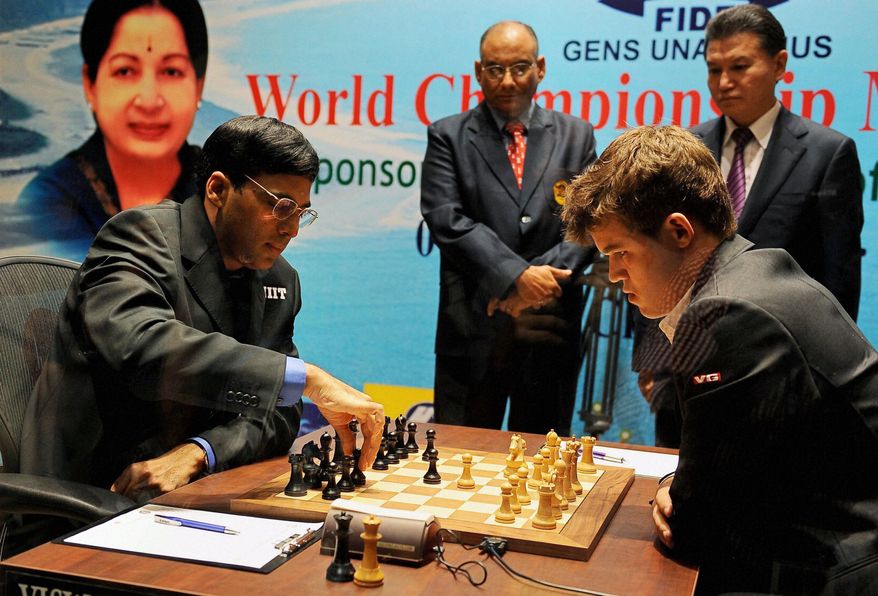 ** FILE ** Defending champion India's Viswanathan Anand, left, makes a move against Norway's Magnus Carlsen during the first game of the World Chess Championship in Chennai, India, Saturday, Nov. 9, 2013. The game ended in a draw. (AP Photo)