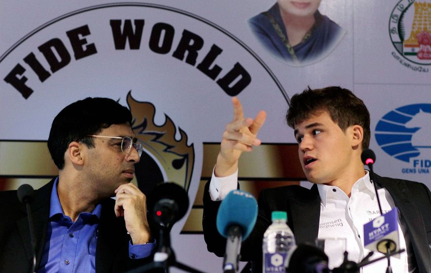 Defending champion India's Viswanathan Anand, left, listens to Norway's Magnus Carlsen during a press conference on the sidelines of the World Chess Championship in Chennai, India, Saturday, Nov. 9, 2013. The first game between the two ended in a draw. (AP Photo)