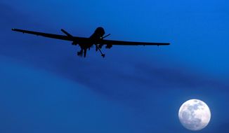 A Predator drone flies over Kandahar Air Field in Afghanistan. (Associated Press) ** FILE **