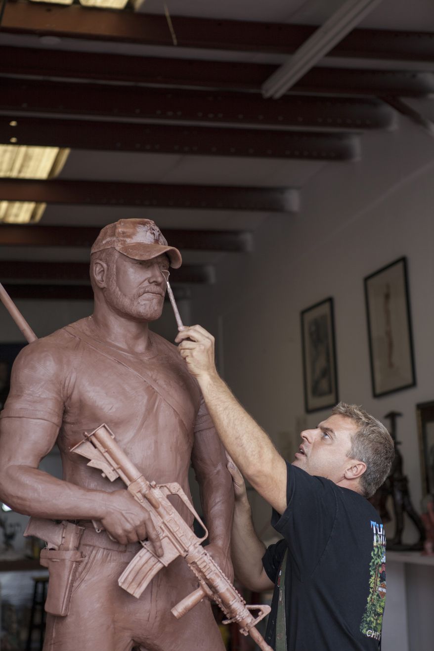 Personal touch: "I know it sounds crazy, but I feel their presence. That's what happens when you're creating a life-sized image of someone," says sculptor Gregory Marra, working on a statue of Chris Kyle, a SEAL sniper killed this year.