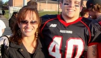 Frostburg State University football player Derek Sheely with his mother, Kristen (right), who says, &quot;We&#39;re haunted with the terrible unreality all the time.&quot; (Photograph provided by the Sheely family)