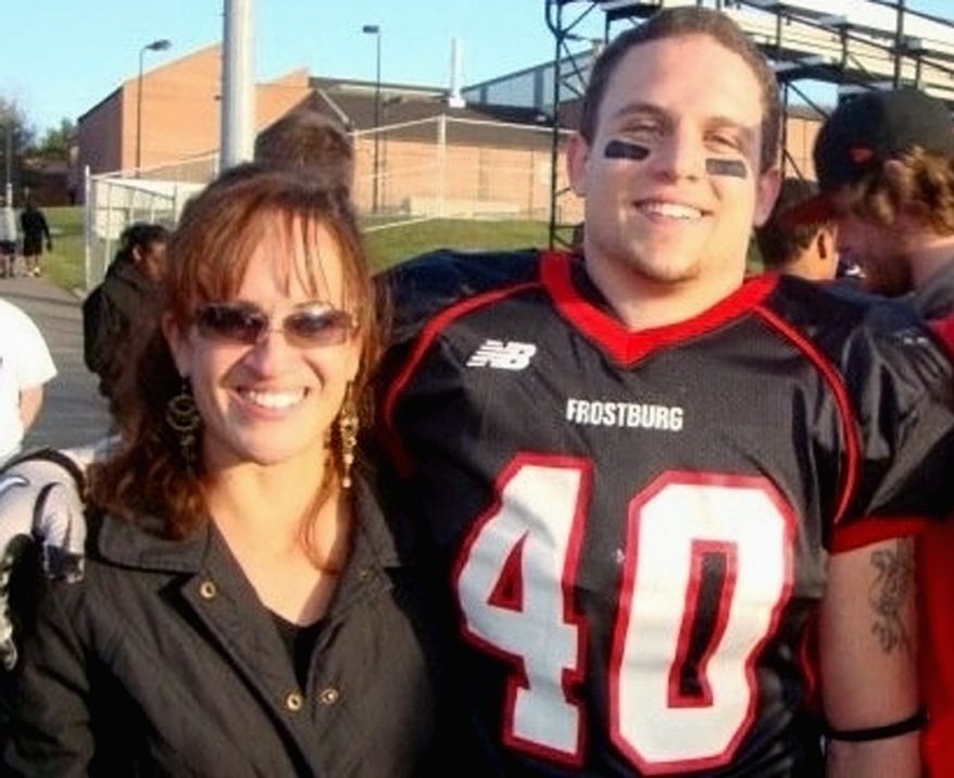 Frostburg State University football player Derek Sheely with his mother, Kristen (right), who says, "We're haunted with the terrible unreality all the time." (Photograph provided by the Sheely family)