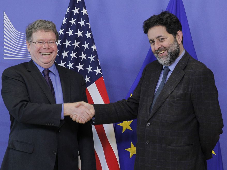 Ignacio Garcia Bercero (right), chief negotiator for the European Union, shakes hands with Daniel Mullaney, U.S. assistant trade representative for Europe and the Middle East, upon arrival at the European Commission headquarters in Brussels on Monday, Nov. 11, 2013. U.S. and EU negotiating teams resumed talks Monday on what could become the biggest trade agreement in history, the Transatlantic Trade and Investment Partnership. (AP Photo/Yves Logghe)