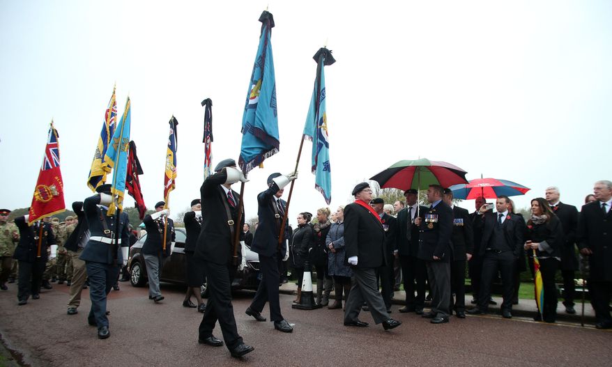 Members of the public, veterans and service personnel gather to pay their respects to World War II airman Harold Percival at Lytham Park Crematorium in Lytham St. Annes, England, on Monday, Nov. 11, 2013. Hundreds attended the funeral for Mr. Percival, who died at age 99, after a nursing home appealed for strangers to come and give him a send-off, since he had no immediate family or close friends. (AP Photo/Press Association, Lynne Cameron)