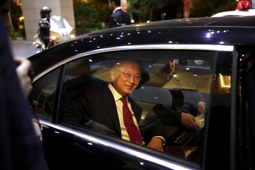 ** FILE ** International Atomic Energy Agency (IAEA) Director General Yukiya Amano leaves the Azadi Hotel after briefing reporters on the progress of nuclear negotiations with Iranian officials in Tehran, Iran, Monday, Nov. 11, 2013. Iran and the U.N. nuclear watchdog agency have reached a roadmap deal for cooperation during talks in Tehran Saturday that expands the monitoring of the country's nuclear sites. (AP Photo/Ebrahim Noroozi)