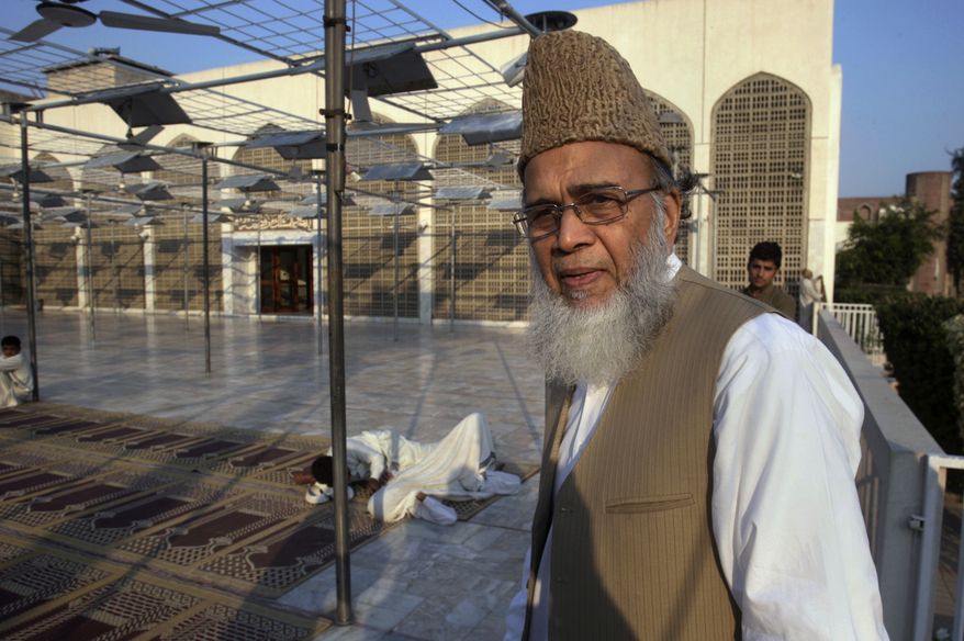 ** FILE ** Syed Munawar Hasan, the head of the Jamaat-e-Islami party, arrives to pray at a mosque in the party's headquarters in Lahore, Pakistan, Monday, Nov, 11, 2013. The Pakistan army condemned the prominent Islamic political leader Hasan who called the Pakistani Taliban chief killed by a U.S. drone strike a martyr. (AP Photo/K.M. Chaudary)