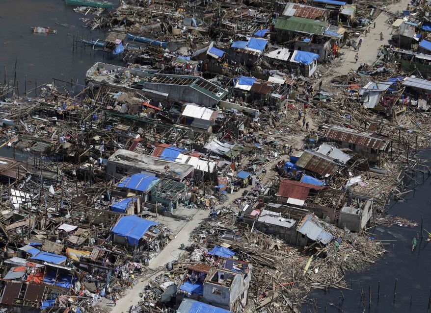 An aerial image taken from a Philippine Air Force helicopter shows the devastation caused by typhoon Haiyan in Guiuan, Eastern Samar province, central Philippines Monday, Nov. 11, 2013. Authorities said at least 2 million people in 41 provinces had been affected by Friday's disaster and at least 23,000 houses had been damaged or destroyed. (AP Photo/Bullit Marquez)