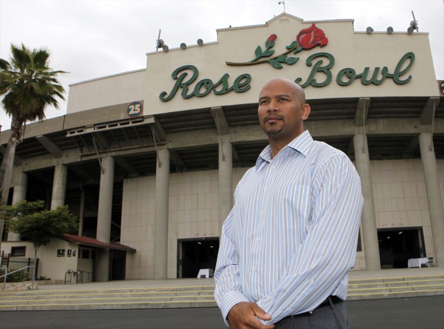 In this photo taken on Thursday, May 27, 2010, Ramogi Huma, president of the National College Players Association, poses for a photo outside the Rose Bowl in Pasadena, Calif. Huma has seen his organization grow to 14,000 members, thanks to the rise of social media and an Internet-driven recruitment strategy. About half the group's members are current athletes, representing 150 Division I programs. (AP Photo/Damian Dovarganes)