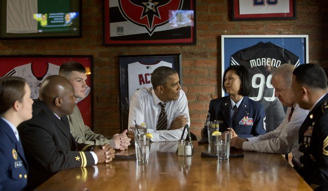 President Barack Obama and Vice President Joe Biden, second from right, meet with five active duty service members at Molly Malone&#x27;s on Barracks Row in Washington, Tuesday, Nov. 12, 2013. (AP Photo/Pablo Martinez Monsivais)