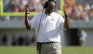 Virginia head coach Mike London reacts to a call during the second half of an NCAA college football game in Charlottesville, Va., Saturday, Oct. 5, 2013. Ball State won the game 48-27.   (AP Photo/Steve Helber)