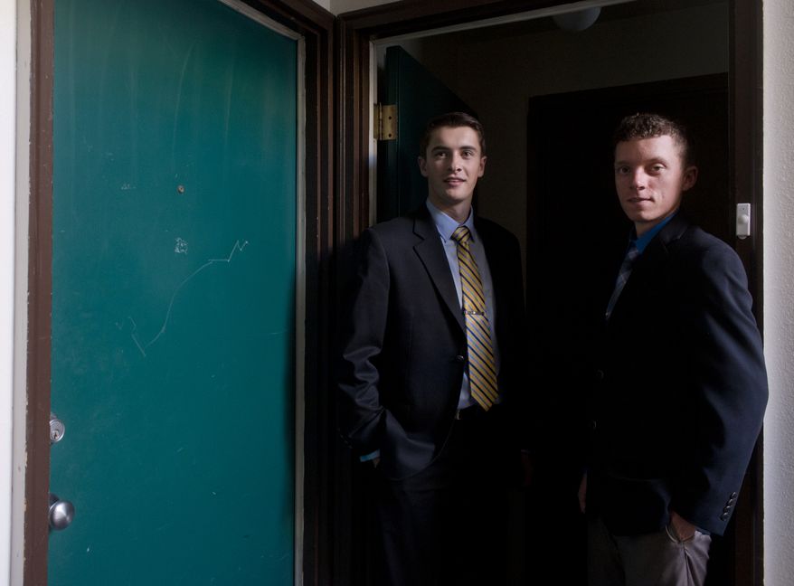 Gonzaga University students Erik Fagan (left) and Dan McIntosh stand in the doorway at their college-owned apartment on Friday, Nov. 8, 2013, in Spokane, Wash. They face expulsion for having a gun in a campus apartment. (AP Photo/The Spokesman-Review, Jesse Tinsley)