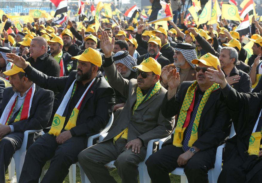 Supporters of Iraq's largest Shiite party, the Supreme Islamic Iraqi Council, listen to their leader, Ammar al-Hakim, during a rally to mark Muharram, an important period of mourning for Shiites, in Baghdad on Wednesday, Nov. 13, 2013. The Remembrance of Muharram marks the anniversary of the Battle of Karbala, during which Imam Hussein, a grandson of Prophet Muhammad, was killed. (AP Photo/Karim Kadim)
