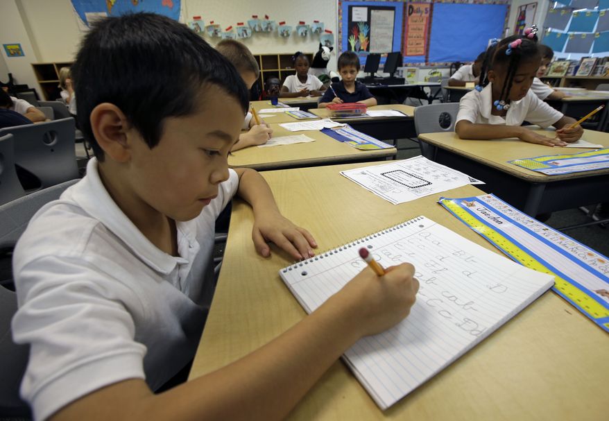 Jaeden Alvarez practices cursive writing at Cleveland K-6 School, Wednesday, Sept. 18, 2013, in Dayton, Ohio. In years gone by, penmanship helped distinguish the literate from the illiterate. But now, in the digital age, people are increasingly communicating by computer and smartphone. No handwritten signature necessary. Cursive writing is not being taught in many schools as some 45 states have adopted Common Core standards, which have eliminated the teaching of cursive writing. (AP Photo/Al Behrman)