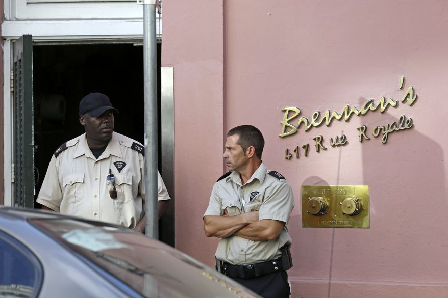 Security guards stand in front of the now-closed Brennan's Restaurant in New Orleans on Friday, June 28, 2013. (AP Photo/Gerald Herbert)