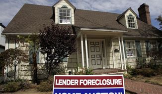 A home is advertised for sale at a foreclosure auction in Pasadena, Calif., in 2007. (AP Photo/Reed Saxon)