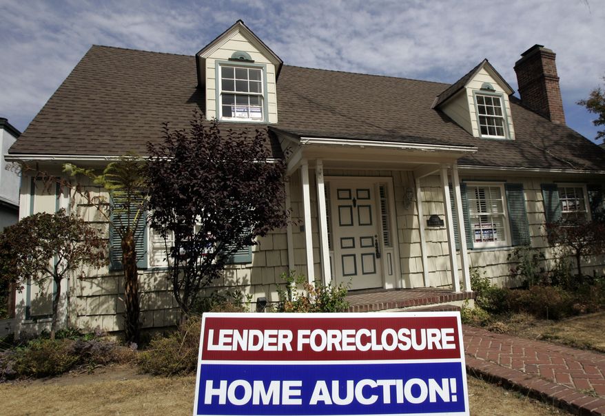 A home is advertised for sale at a foreclosure auction in Pasadena, Calif., in 2007. (AP Photo/Reed Saxon)