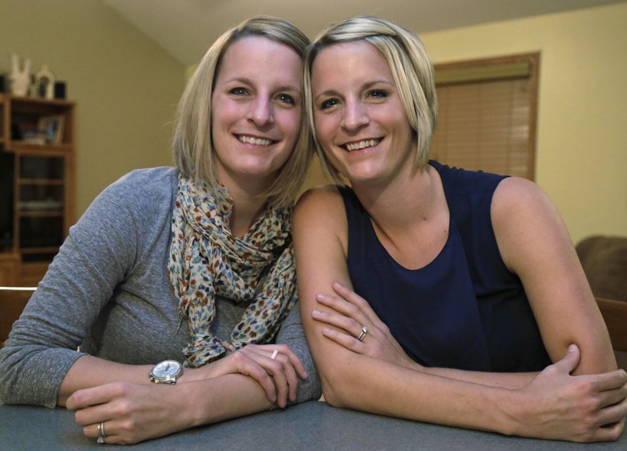 This Monday, Nov. 11, 2013 photo shows identical twins Kristen Maurer, left, and Kelly McCarthy at Kelly's mother-in-law’s house in Beecher, Ill. The 34-year-old sisters from Crown Point, Ind., have shared a lot in their lives so when Kelly was diagnosed with breast cancer in 2011, she urged Kristen to get tested, too. Kristen also was diagnosed with breast cancer. Now the twins are sharing a medical rarity: Kristen donated skin and fat tissue for Kelly's breast reconstruction surgery that was performed at the University of Chicago Medical Center by breast cancer surgeon, Dr. David Song on Tuesday, Nov. 12. (AP Photo/M. Spencer Green)