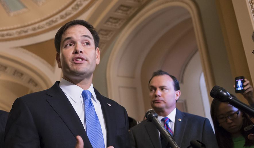 Sen. Marco Rubio (left), Florida Republican, accompanied by Sen. Mike Lee, Utah Republican, speaks to reporters during a news conference on Capitol Hill in Washington in this Sept. 27, 2013, file photo. (AP Photo/J. Scott Applewhite, File) ** FILE **