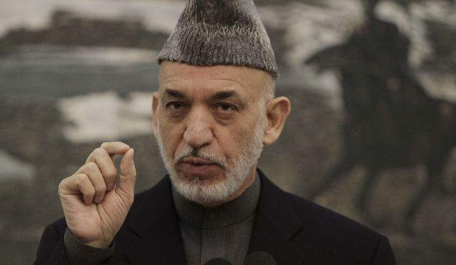 Afghan President Hamid Karzai gestures during a press conference at the presidential palace in Kabul, Saturday, Nov. 16, 2013. Karzai announced that the final draft of a contentious Bilateral Security Agreement with the United States has been completed ahead of a traditional loya Jirga, or grand council, convened to discuss the critical pact. Both countries have signed off on the draft. (AP Photo/Rahmat Gul)