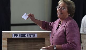 Former Chilean President Michelle Bachelet casts her vote during general elections in Santiago, Chile, on Sunday, Nov. 17, 2013. Ms. Bachelet is the front-runner in her race to regain the presidency. (AP Photo/Luis Hidalgo)