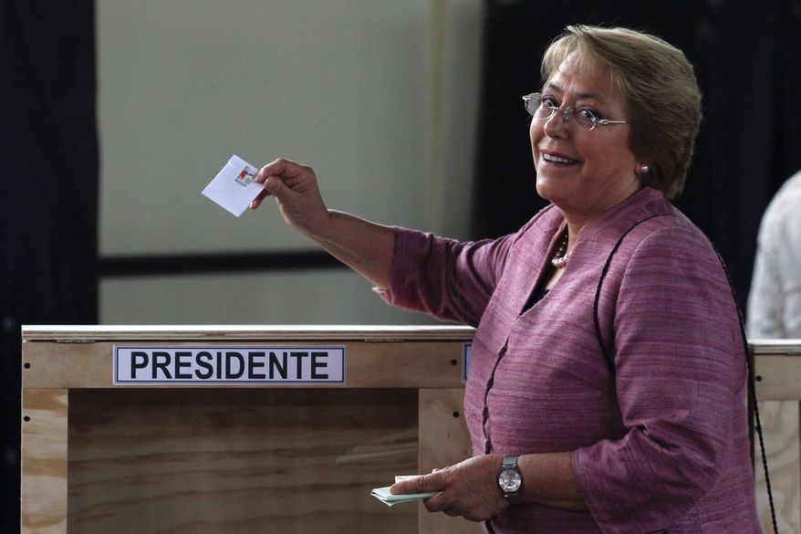 Former Chilean President Michelle Bachelet casts her vote during general elections in Santiago, Chile, on Sunday, Nov. 17, 2013. Ms. Bachelet is the front-runner in her race to regain the presidency. (AP Photo/Luis Hidalgo)