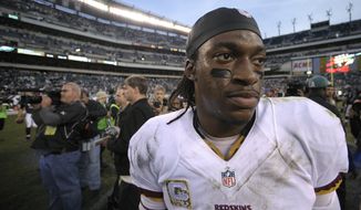 Washington Redskins quarterback Robert Griffin III walks off the field after an NFL football game against the Philadelphia Eagles in Philadelphia, Sunday, Nov. 17, 2013. The Eagles defeated the Redskins 24-16. (AP Photo/Michael Perez)