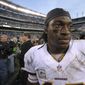 Washington Redskins quarterback Robert Griffin III walks off the field after an NFL football game against the Philadelphia Eagles in Philadelphia, Sunday, Nov. 17, 2013. The Eagles defeated the Redskins 24-16. (AP Photo/Michael Perez)