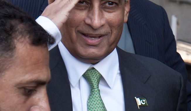 ** FILE ** In this Monday, Jan. 9, 2012, file photo, Pakistan&#x27;s former ambassador to the U.S., Husain Haqqani salutes to media as he leaves after appearing before a judicial commission at a high court in Islamabad, Pakistan.  (AP Photo/Anjum Naveed, File)
