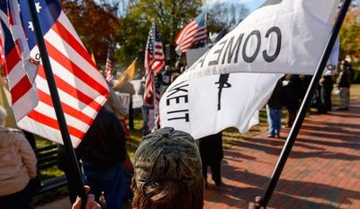 Doug Allen of Greenville, N.C., holds a flag depicting an assault riffle with the words &quot;Come and Take It&quot; as he joins protesters organized by the Reclaim America Now Coalition in Lafayette Square on Tuesday demanding President Obama&#39;s resignation. (andrew harnik/the washington times)