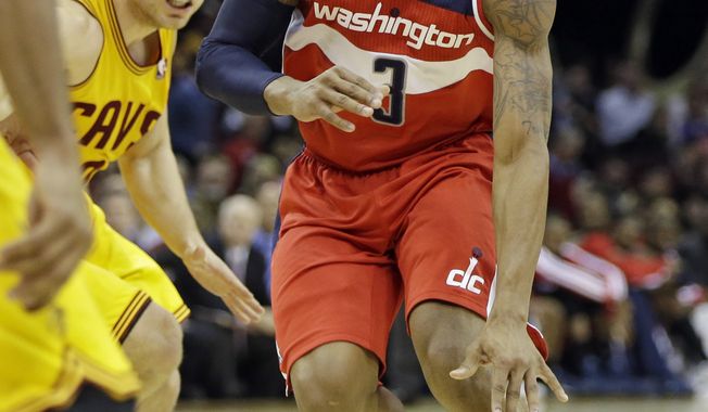 Washington Wizards&#x27; Bradley Beal (3) drives past Cleveland Cavaliers&#x27; Matthew Dellavedova, from Australia, in the third quarter of an NBA basketball game on Wednesday, Nov. 20, 2013, in Cleveland. Beal scored 26 points in the Wizards&#x27; 98-91 win. (AP Photo/Mark Duncan)