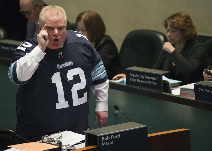 **FILE** Mayor Rob Ford speaks to city council members about new allegations against him in Toronto on Thursday, Nov. 14, 2013. Ford is threatening to take legal action against former aides who told police about their concerns about his drug use and drunken driving. He also denies making sexual advances toward a female staffer. (Associated Press/The Canadian Press, Nathan Denette)