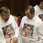 Opposition lawmakers wear shirts emblazoned with a photo of jailed former Premier Yulia Tymoshenko during a session of the Ukrainian parliament in Kiev on Friday, Nov. 8, 2013. (AP Photo/Sergei Chuzavkov)