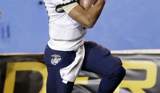 Navy quarterback Keenan Reynolds celebrates as he score the game-winning touchdown in  triple overtime for a 58-52 win over San Jose State in an NCAA college football game on Friday, Nov. 22, 2013, in San Jose, Calif.  N (AP Photo/Marcio Jose Sanchez)