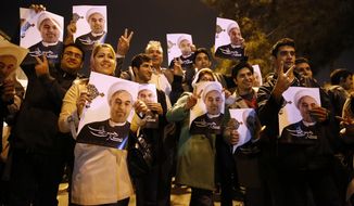 In this photo released by the Iranian Students News Agency, ISNA, Iranians hold posters of President Hassan Rouhani as they welcome Iranian nuclear negotiators upon their arrival from Geneva at the Mehrabad airport in Tehran, Iran, Sunday, Nov. 24, 2013. Hundreds of cheering supporters greeted Iran&#39;s nuclear negotiators as they arrived back to Tehran late Sunday night. Tehran agreed Sunday to a six-month pause of its nuclear program while diplomats continue talks. International observers are set to monitor Iran&#39;s nuclear sites as the West eases about $7 billion of the economic sanctions crippling the Islamic Republic. (AP Photo/ISNA,Hemmat Khahi)