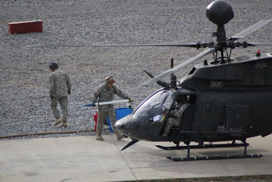 Soldiers from the 2nd Squadron, 17th Cavalry Regiment, 101st Airborne Division at Fort Campbell, Ky., reload rockets onto a helicopter during a training exercise on Friday, Nov. 22, 2013. The unit was able to continue flying training missions during the government shutdown and budget cutbacks by purchasing spare parts for helicopters over the summer before budget restrictions took effect. (AP Photo/Brett Barrouquere)