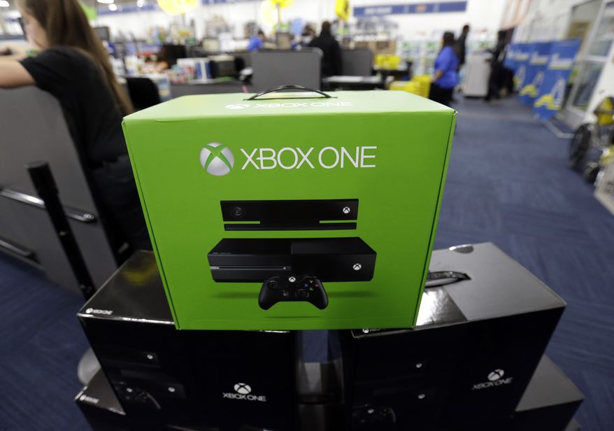 FILE - In this Friday, Nov. 22, 2013 file photo, The Xbox One is on display at a Best Buy store in Evanston, Ill. There's a couple of new foes affecting gamers who are proving to be far more destructive than any on-screen villains. With foreboding nicknames like "the blue light of death" and "the disc drive of doom," they're the glitches putting a hamper on the next-generation gaming systems Xbox One and PlayStation 4. (AP Photo/Nam Y. Huh, File)