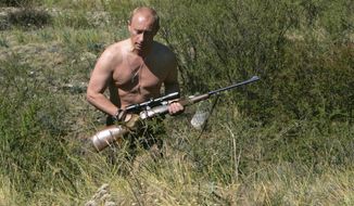 FILE - In this Sept. 2010 photo released on Saturday, Oct. 30, 2010, then Russian Prime Minister Vladimir Putin carries a hunting rifle during his trip in Ubsunur Hollow in the Siberian Tyva region (also referred to as Tuva), on the border with Mongolia, Russia.   Vladimir Putin turns 60-years old on Sunday, Oct. 7, 2012, and has recently sought to demonstrate his youthful vigor by many personal endeavors, but while he has shown creativity in his action-man stunts, the Russian president seems surprisingly vulnerable to the vagaries of oil prices. (AP Photo/RIA Novosti, Dmitry Astakhov, Government Press Service, file)