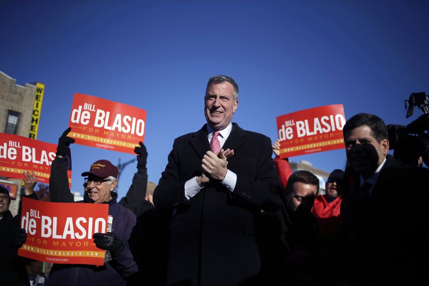 Democratic New York City mayoral candidate Bill de Blasio campaigns at a subway stop in New York, Monday, Nov. 4, 2013. The mayoral election will take place on Tuesday, Nov. 5, 2013. (AP Photo/Seth Wenig)