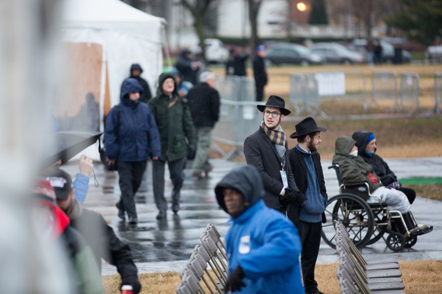 Visitors endure snow, rain and the cold during the lighting of the National Menorah, in Washington, DC., Wednesday, November 27, 2013. (Andrew S Geraci/The Washington Times)