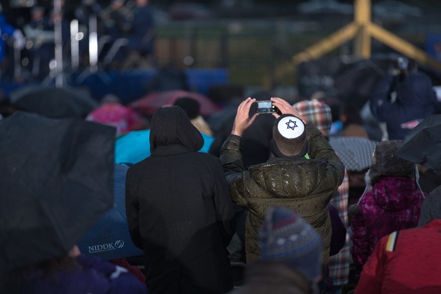 Visitors endure snow, rain and the cold during the lighting of the National Menorah, in Washington, DC., Wednesday, November 27, 2013. (Andrew S Geraci/The Washington Times)