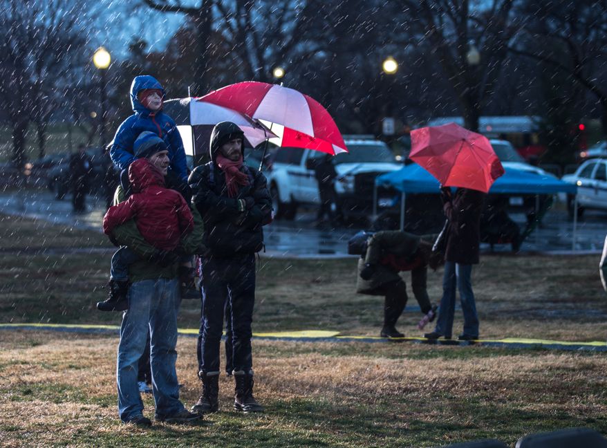 Visitors endure snow, rain and the cold during the lighting of the National Menorah, in Washington, DC., Wednesday, November 27, 2013. (Andrew S Geraci/The Washington Times)